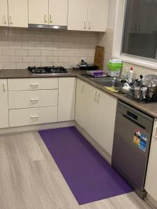 a kitchen with a purple rug on the floor at 76 Companion Crescent in Higgins