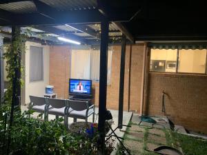 a patio with a table and chairs and a television at 76 Companion Crescent in Higgins +18 photos