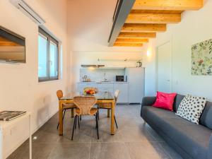 a living room with a table and a couch at Apartment Camping Turisport-4 by Interhome in Dervio