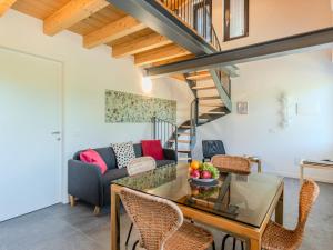 a living room with a table and chairs and a staircase at Apartment Camping Turisport-4 by Interhome in Dervio +24 photos