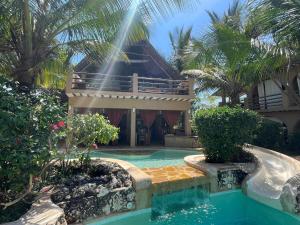 a house with a swimming pool in front of a house at Lapili Residence in Kiwengwa +73 photos