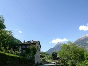 a house on a road with mountains in the background at Holiday Home Casa Jolli by Interhome in Semione