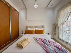a bedroom with a large bed with two pillows on it at Charming Bright Flat in Historic La Ville Haut in Kenitra