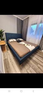 a large bed in a room with a window at AZZURE Apartaments Constanța in Constanţa