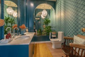 a bathroom with a sink and a toilet and a mirror at Casinha das Flores in Lisbon +38 photos