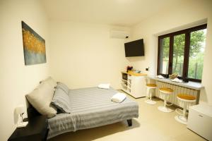 a bedroom with a bed and a desk in it at The One Malpensa Rooms in Vizzola Ticino