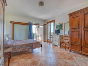 a bedroom with a bed and a table and chairs at Appartamenti dolores castle in Marina di Campo Airport