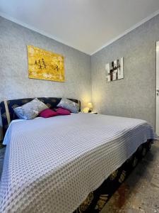 a bedroom with a large white bed with pillows at Kassopia Serenity Place in Lefkimmi
