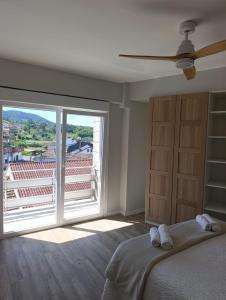 a bedroom with a bed and a large window at J&C Arcade in Arcade