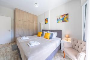 a bedroom with a large bed and a couch at Donna's luxury home in Kassiopi 300m from the sea in Kassiopi