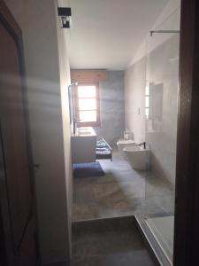 a bathroom with a tub and a sink and a toilet at Big Apartment in Assemini +19 photos