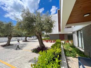 a young child walking in front of a building at Olive Hill 14 Cozy 2-Bed Garden Apt by HolidayKeys in Kérynia