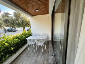 a balcony with a table and chairs on it at Olive Hill 14 Cozy 2-Bed Garden Apt by HolidayKeys in Kérynia
