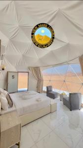 a bedroom with a large bed in a tent at RUM BUBBLES VIEW MARS lUXURY CAMP in Wadi Rum