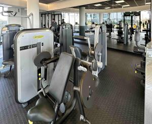 a gym with a row of treadmills and machines at Explore Ellipse - Peacock Room in Midrand