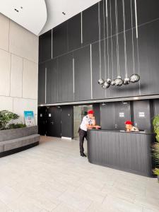 two people are standing at a counter in a kitchen at Gamuda Cove Homestay in Banting +24 photos