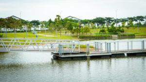 a white bridge over a body of water at Gamuda Cove Homestay in Banting