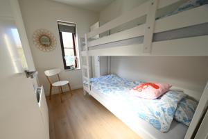 a bedroom with a bunk bed and a desk at The Lanica - Spaanse Galeien 109, luxury holiday home, complety renovated in 2025 in Cadzand