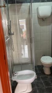 a bathroom with a toilet and a glass shower at Casetta al mare MariaTeresa in Nocera Terinese +32 photos
