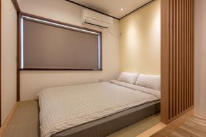 Posteľ alebo postele v izbe v ubytovaní 良居民宿 YOSHII House 晴空塔徒步圈 整栋出租