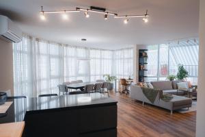 a living room with a couch and a table at Central Penthouse No5 - sky view in Visp