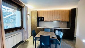 a kitchen with a table and chairs and a window at Residence Villa Linda in Bardonecchia