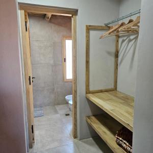 a bathroom with a toilet and a mirror at Cabañas Bodega Kindgard in Purmamarca +27 photos