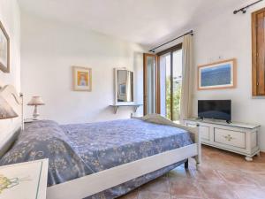 a bedroom with a bed and a desk and a television at Appartamenti dolores castle in Marina di Campo Airport +35 photos