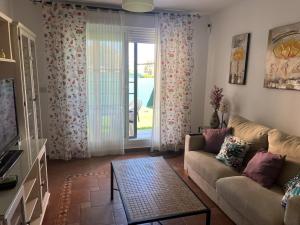 a living room with a couch and a sliding glass door at Vera playa in Vera
