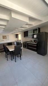 a large kitchen with a table and chairs in it at Ideal for family or friends, downtown area in Mendoza