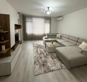 a living room with a couch and a table at Cozy Home 2 Bedroom apartment in Kyustendil