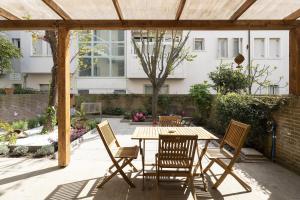 a patio with a wooden table and chairs at Ca'do garden apartament in Venice