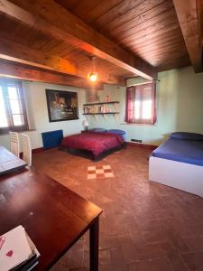 a living room with a bed and a table at La casa colorata nel cuore della Venezia in Livorno