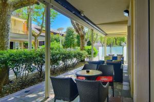 a patio with a table and chairs on a patio at Hotel Madison in Bellaria-Igea Marina