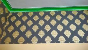 a room with a blue and gold wallpaper at Krishna plaza in Sālpura