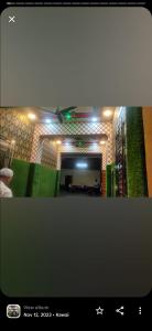 a picture of a living room with lights on the wall at Krishna plaza in Sālpura