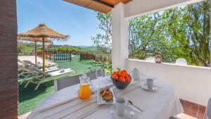 a white table with a bowl of fruit on it at Casa La Niña Antequera - La Joya by Ruralidays in Antequera