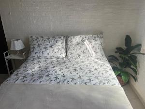 a bed with a white bedspread with fish on it at Bandeira do Brasil in Rio de Janeiro
