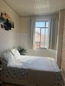 a bedroom with a white bed and a window at Bandeira do Brasil in Rio de Janeiro