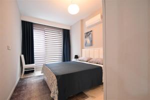 a bedroom with a bed and a window at 0017 White Sail Cozy 1-Bedroom Apartment Steps from Yekta Mall in Mahmutlar, Alanya in Alanya +28 photos