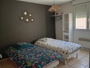 a small bedroom with a bed and a shelf at Le pigeonnier in Millau