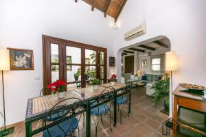 a dining room with a table and chairs and a living room at La Casa de la Iglesia in Mijas +75 photos