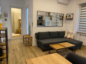 a living room with a couch and a table at ZEFIRO OSTIA-Free parking & Terrace in Lido di Ostia