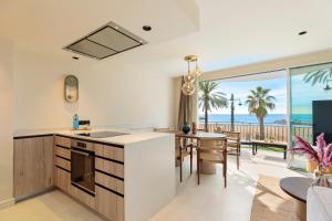 a kitchen and dining room with a view of the ocean at Sitges Group Ocean in Sitges