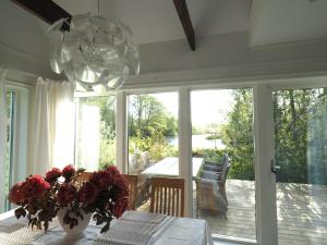 a dining room with a table and a chandelier at Villa Svanviken in Svedala