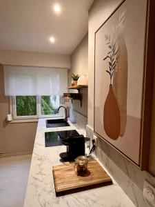 a kitchen with a wooden cutting board on a counter at La Rose in Schiltigheim
