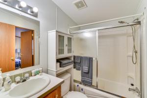 a bathroom with a sink and a toilet and a shower at Waterfront Home with Boat Slips in Northern Michigan in Gladwin +23 photos