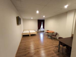 an empty room with a table and chairs in it at Vieta tavai atputai ar grilu in Liepāja