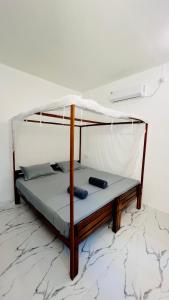 a bedroom with a bunk bed in a room at The Woodnest in Arugam Bay