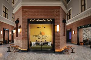 a room with a couch in a brick wall at Moxy Istanbul Taksim by Marriott Bonvoy in Istanbul +53 photos